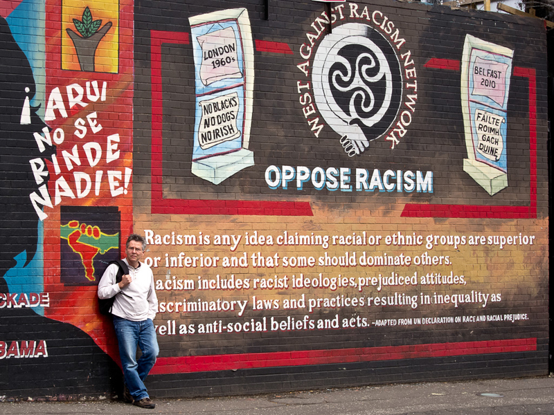 Ray Owen in front of a mural in Belfast